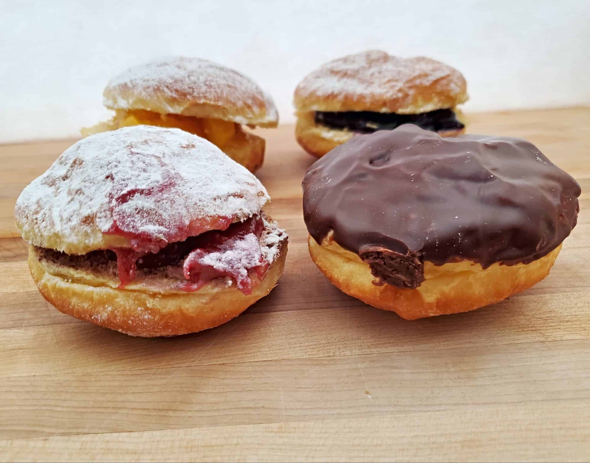 Paczki from Lilac Bakery on a cutting board.