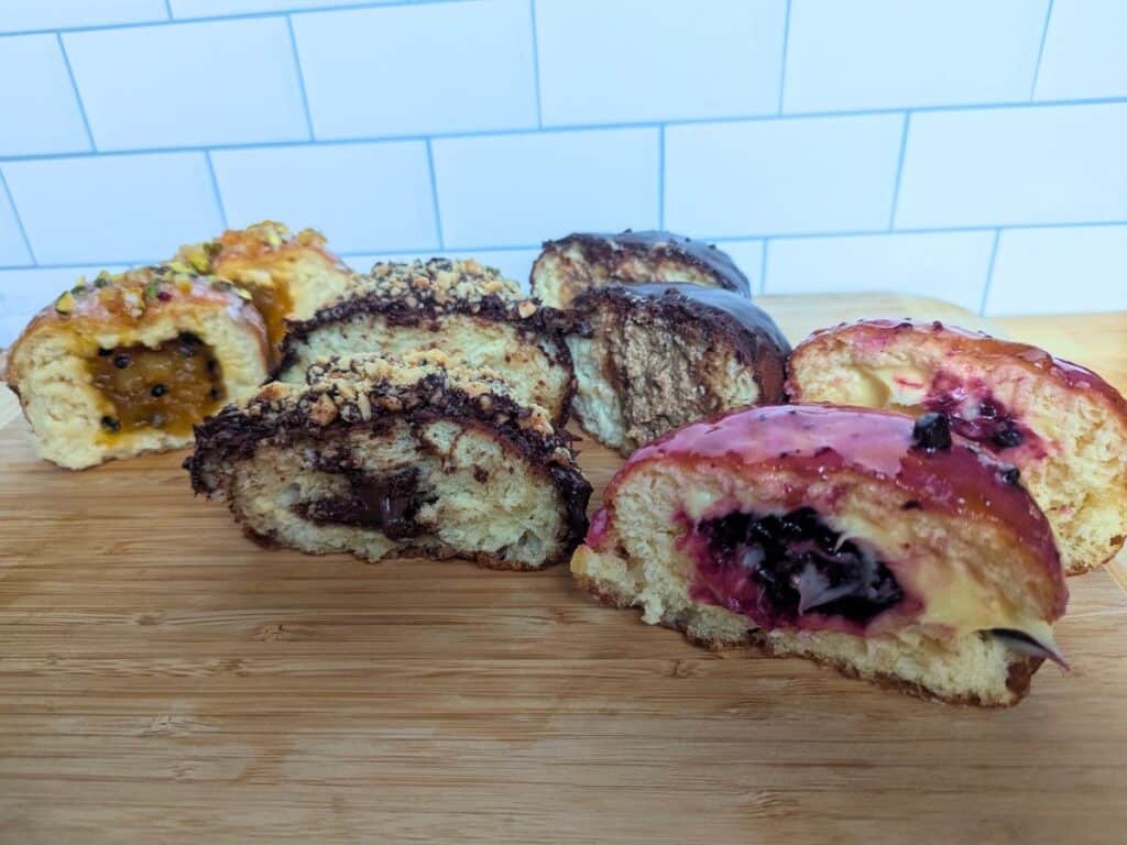 Image shows four paczki flavors from Sweet Generations Bakery in Wood Dale.