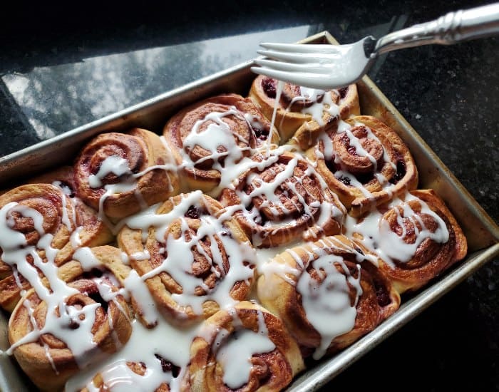Drizzle glaze over cherry rolls