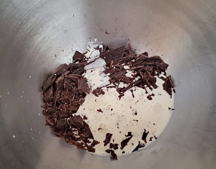 Pour hot cream over chocolate