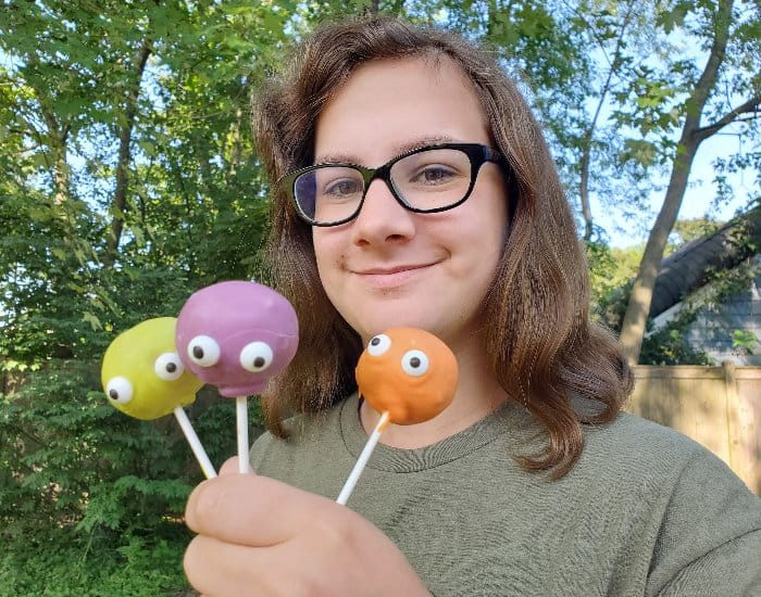 Girl holding monster cake pops