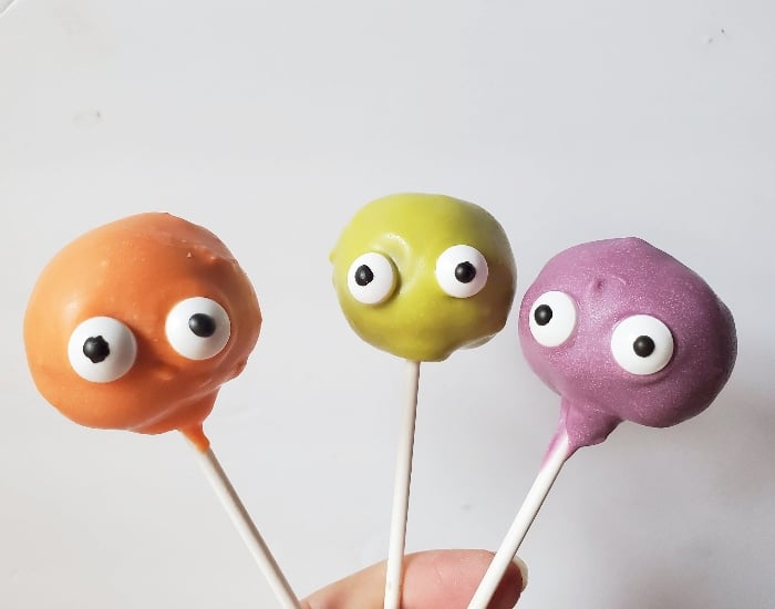 Holding 3 monster cake pops