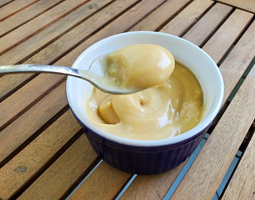 Bite of butterscotch pudding on a spoon.