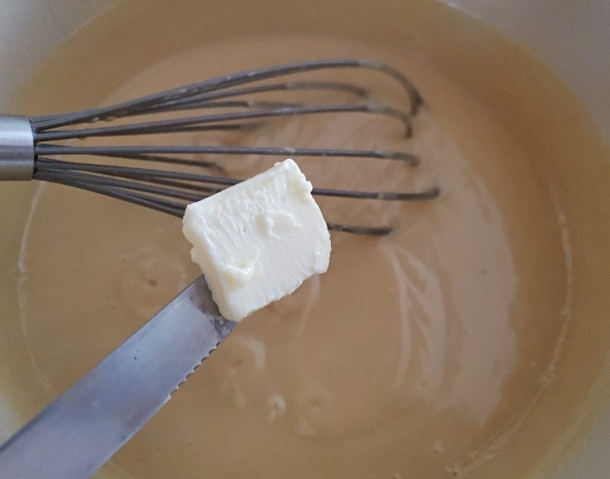 Cut butter into pieces to add to hot pudding