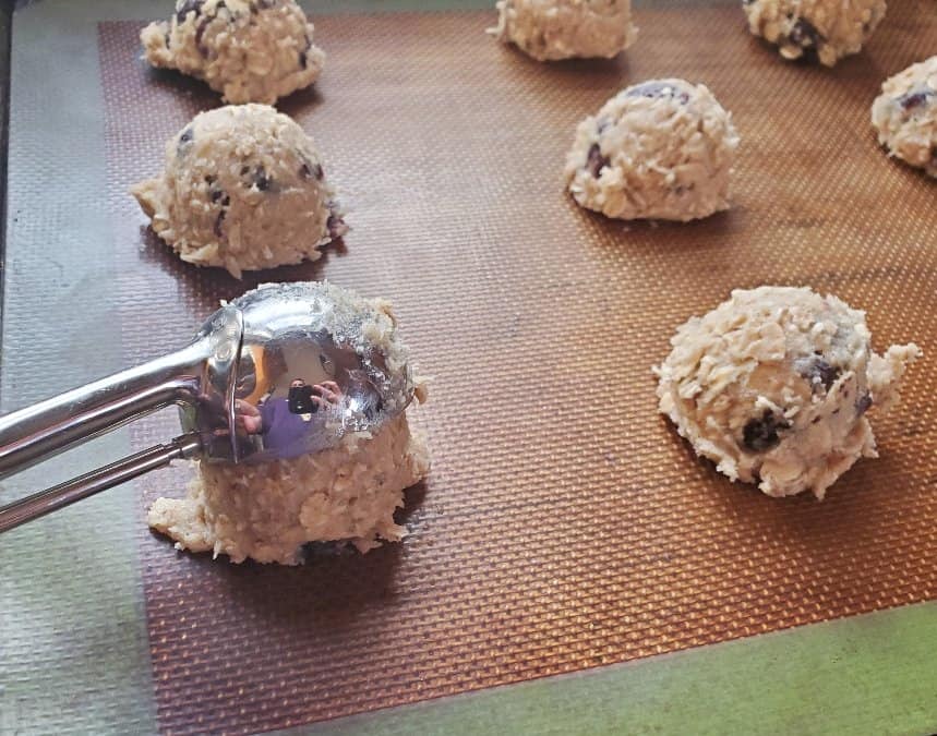 Placing a cookie on a cookie sheet with a cookie scoop