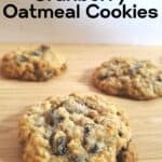 Three oatmeal cookies on a wooden plate