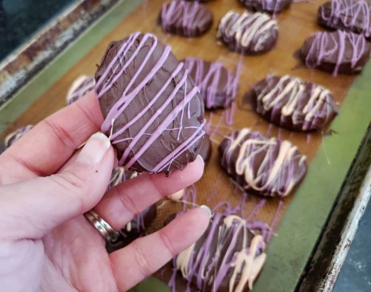 Holding up a chocolate easter egg cookie dough truffle.