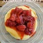 Overhead closeup of pancakes with strawberry syrup