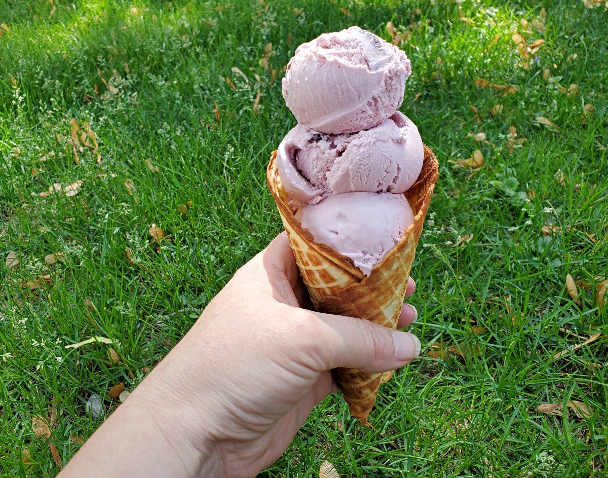 Cherry ice cream in a waffle cone