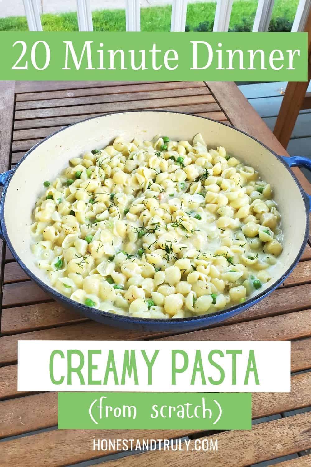 Pot of shells pasta with white sauce on a wooden table.
