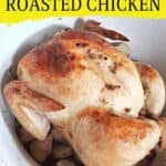 Roast chicken in a white pot with text easy lemon roasted chicken.