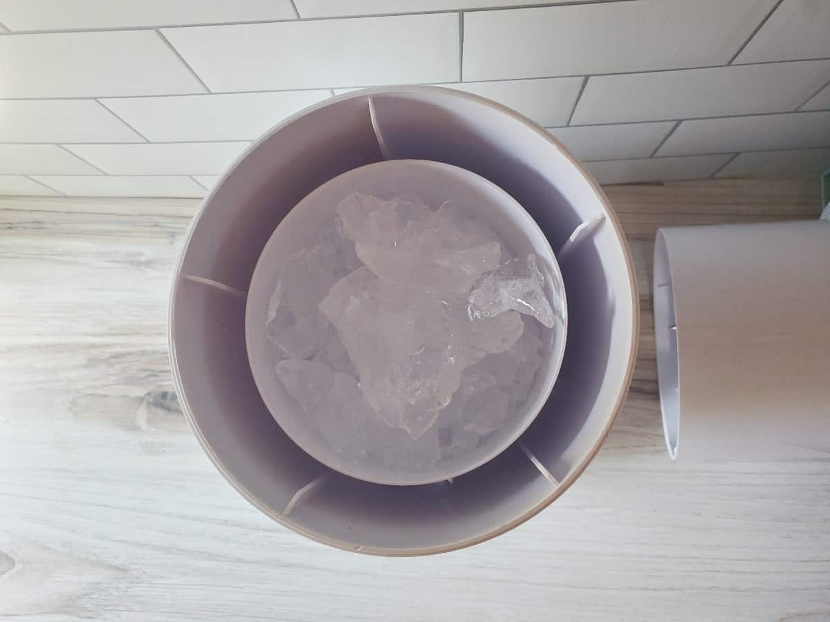 Overhead shot showing ice added to a shaved ice machine.