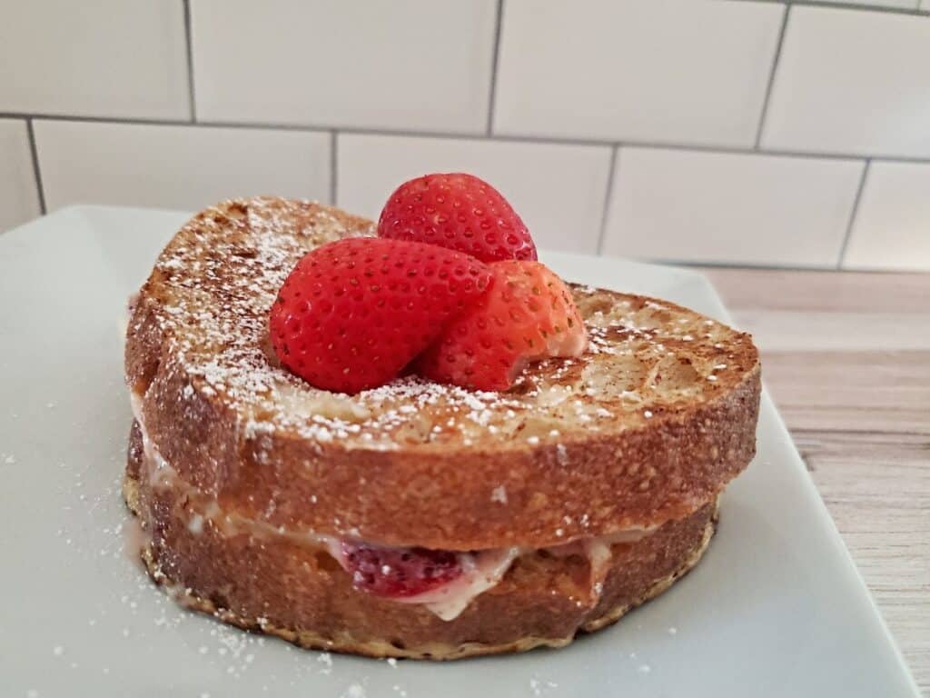 Strawberry french toast on a white plate.