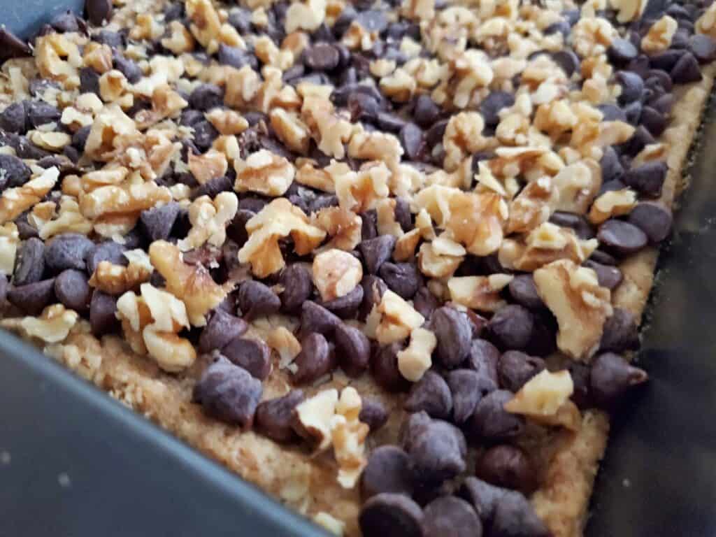Chocolate and nuts sprinkled on crumb crust.