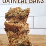 Stack of crumb bars with text chocolate caramel oatmeal bars.