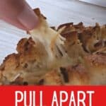 Removing a piece of cheesy pull apart bread with text pull apart bread.