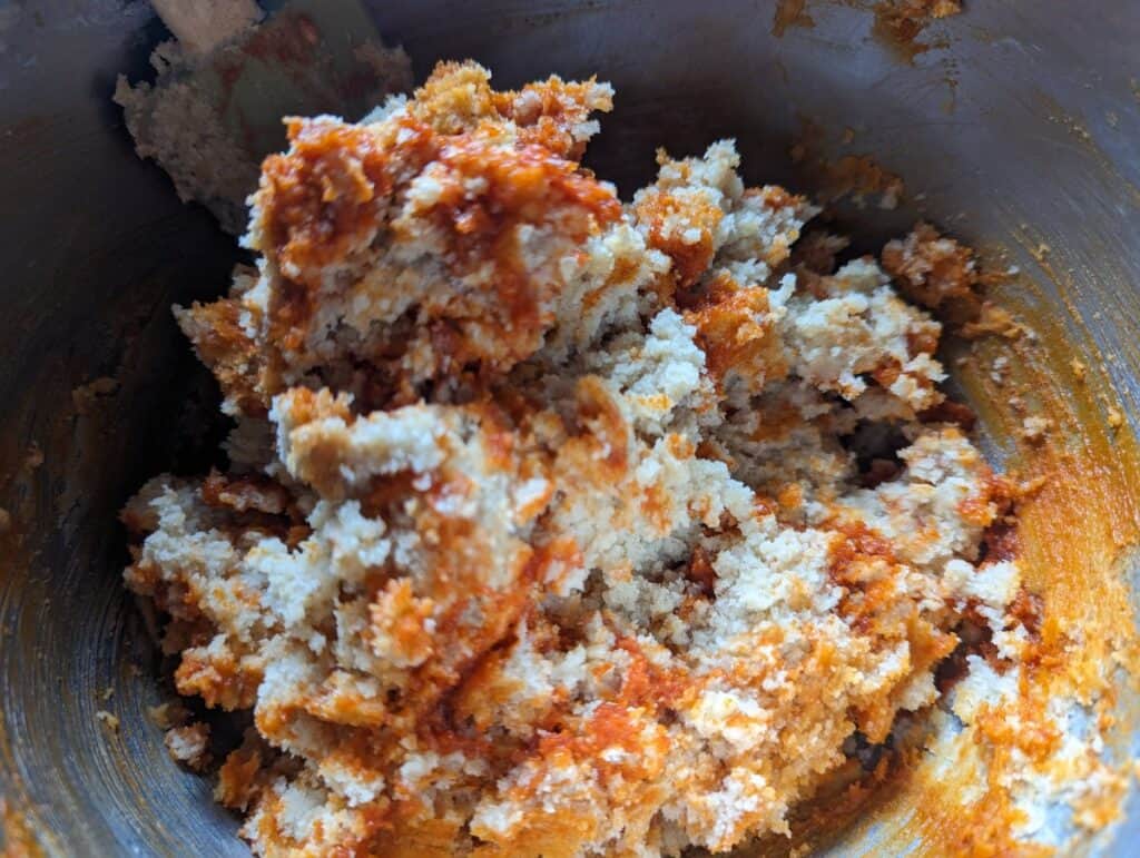 Bowl of cookie dough with gochujang caramel ribbons in it.