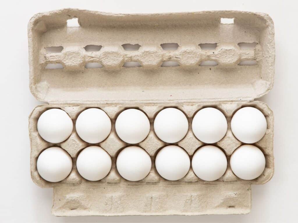 Overhead of a carton of a dozen eggs.