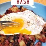 Fork cutting into runny egg over hash with text corned beef hash.