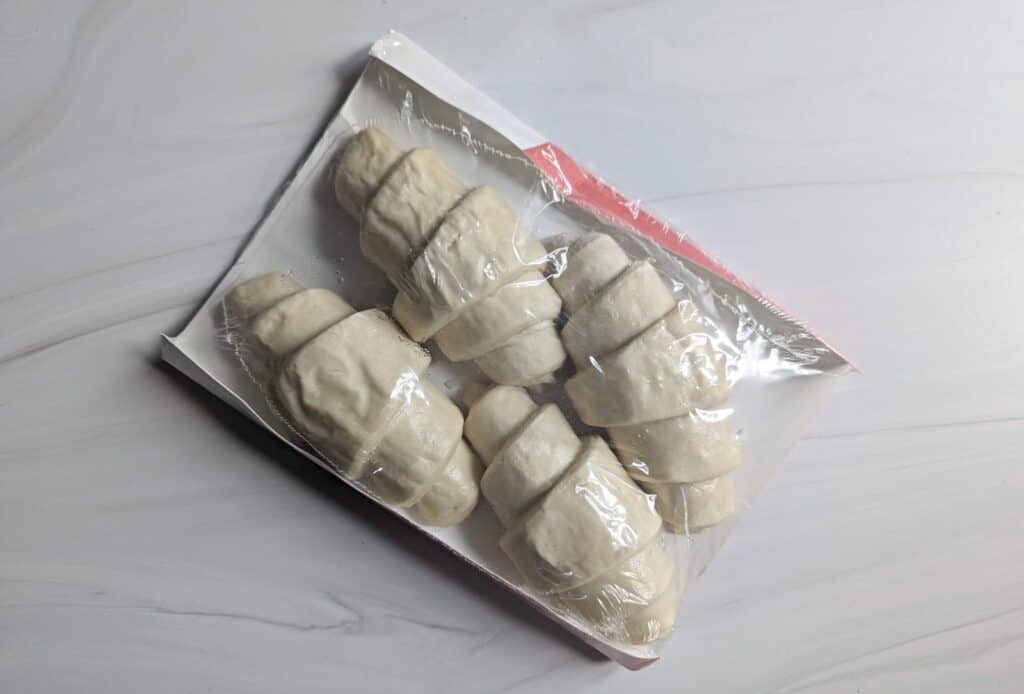 Overhead image of frozen Wildgrain croissants in the package on a marble counter.