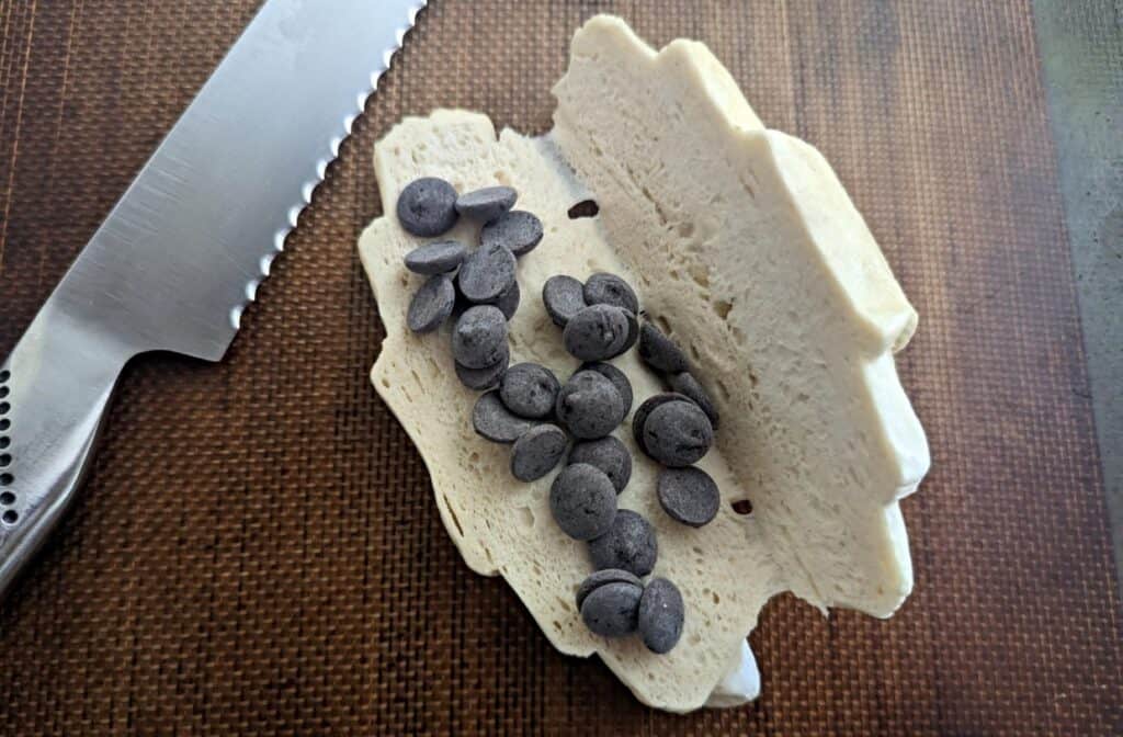 Overhead of half a croissant with chocolate chips in it.