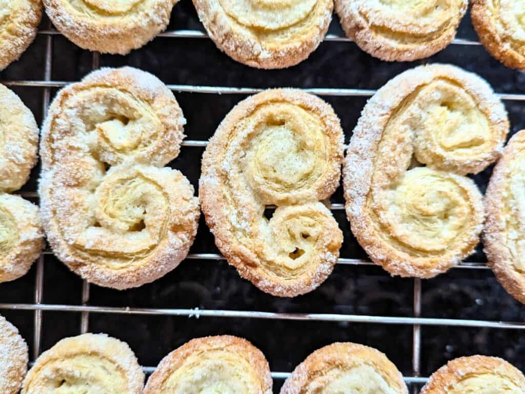 Image shows an Overhead of palmiers on a cooling rack.