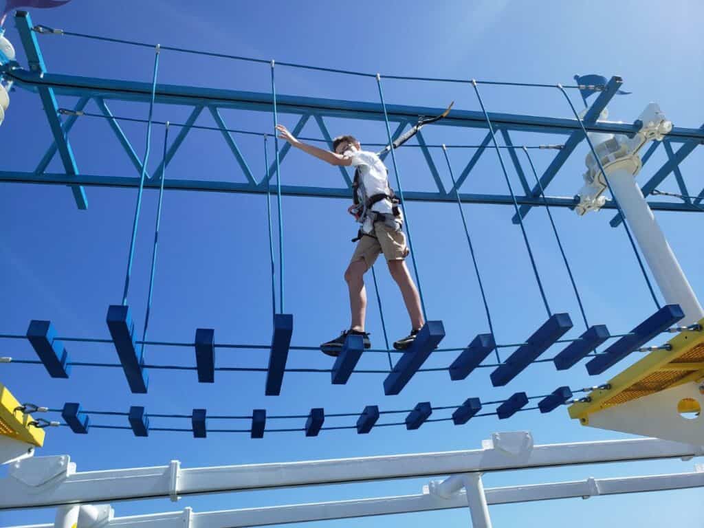 Image shows a Teen doing a ropes course.