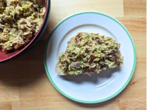Image shows Pesto tomato salad sandwich and bowl from overhead.
