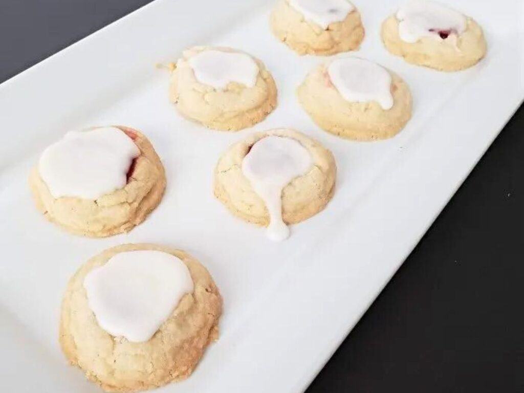 Image shows classic thumbprint cookies served on a plate.