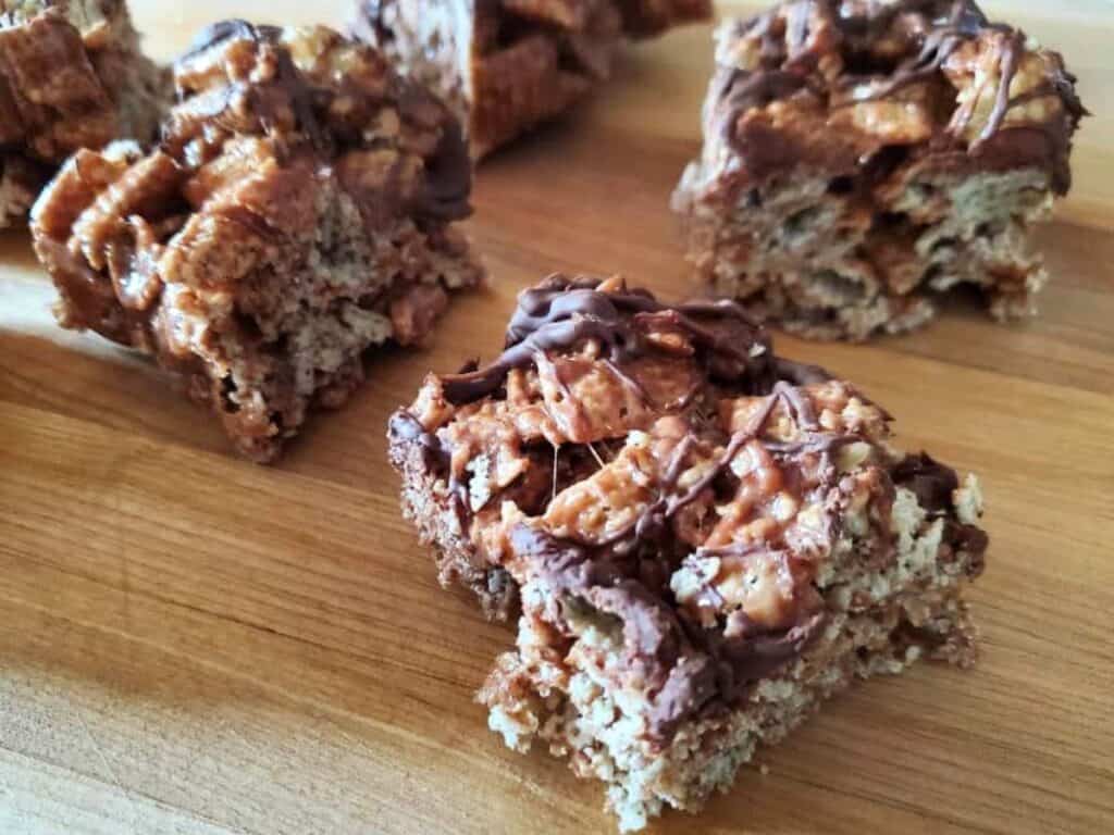 Image shows delicious double chocolate peppermint cereal bars on a wooden tray.