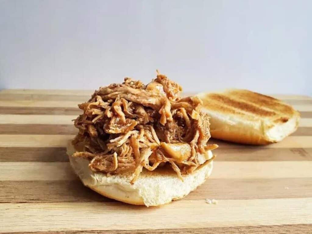 Image shows delicious instant pot shredded chicken sandwich,