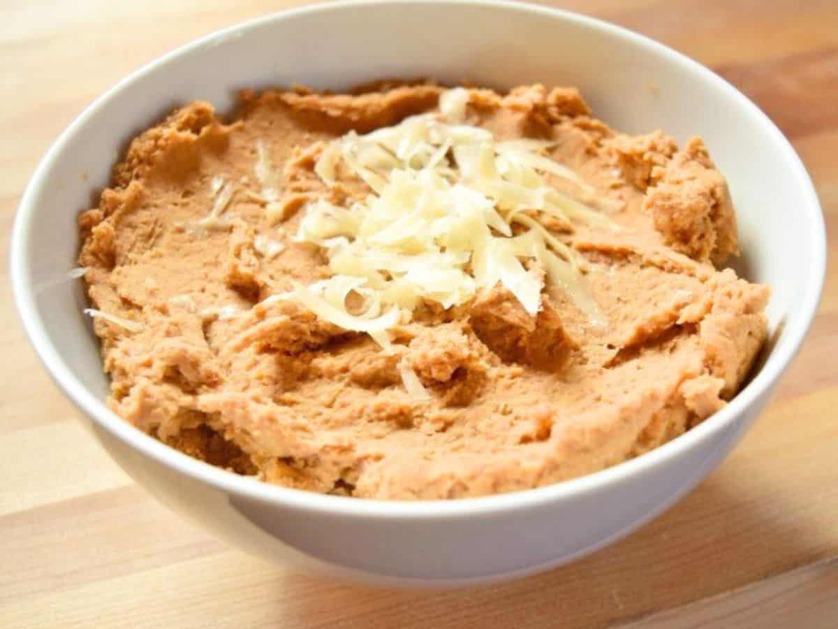 Image shows a bowl of Refried Beans up close.
