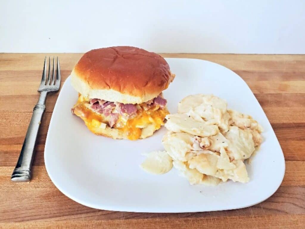 Image shows hot ham salad sandwich plated and served.