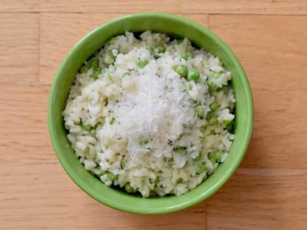 Image shows instant pot pea risotto in a bowl.
