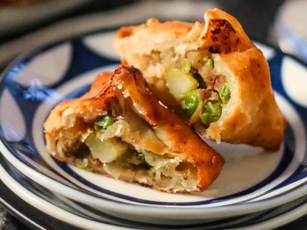 Image shows irresistible fried samosas.