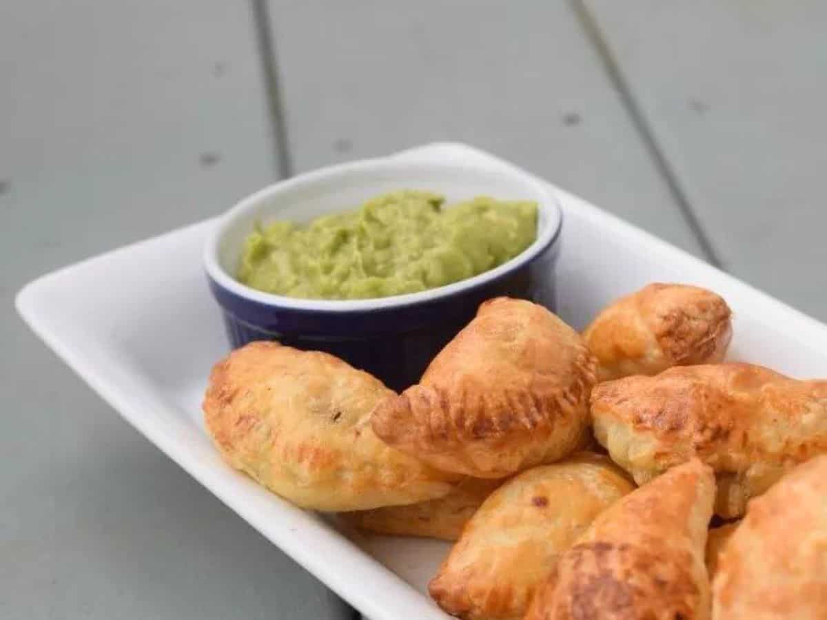 Image shows plate full of puff pastry beef empanadas.