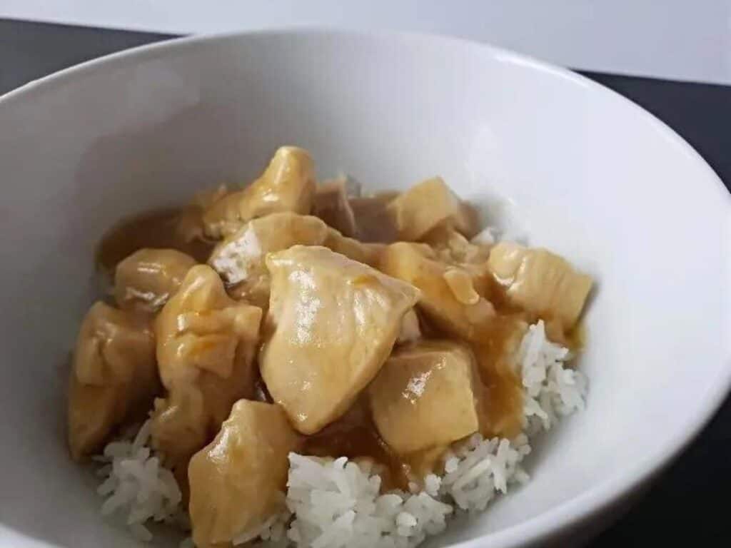 Image shows rice topped with delicious orange chicken.