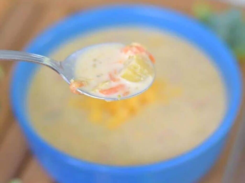 Image shows spoonful of instant pot broccoli and cheddar soup.