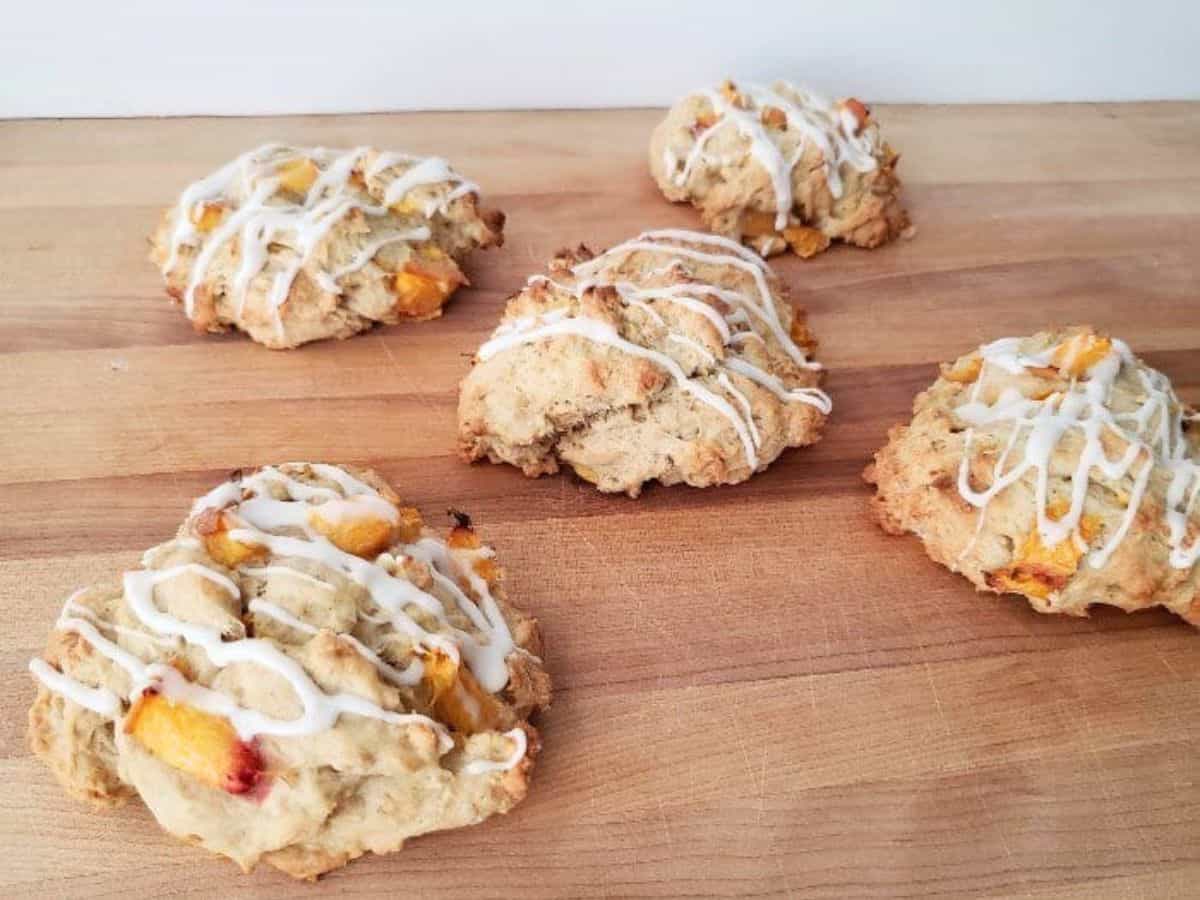 Image shows Peach scones with icing on a cutting board.