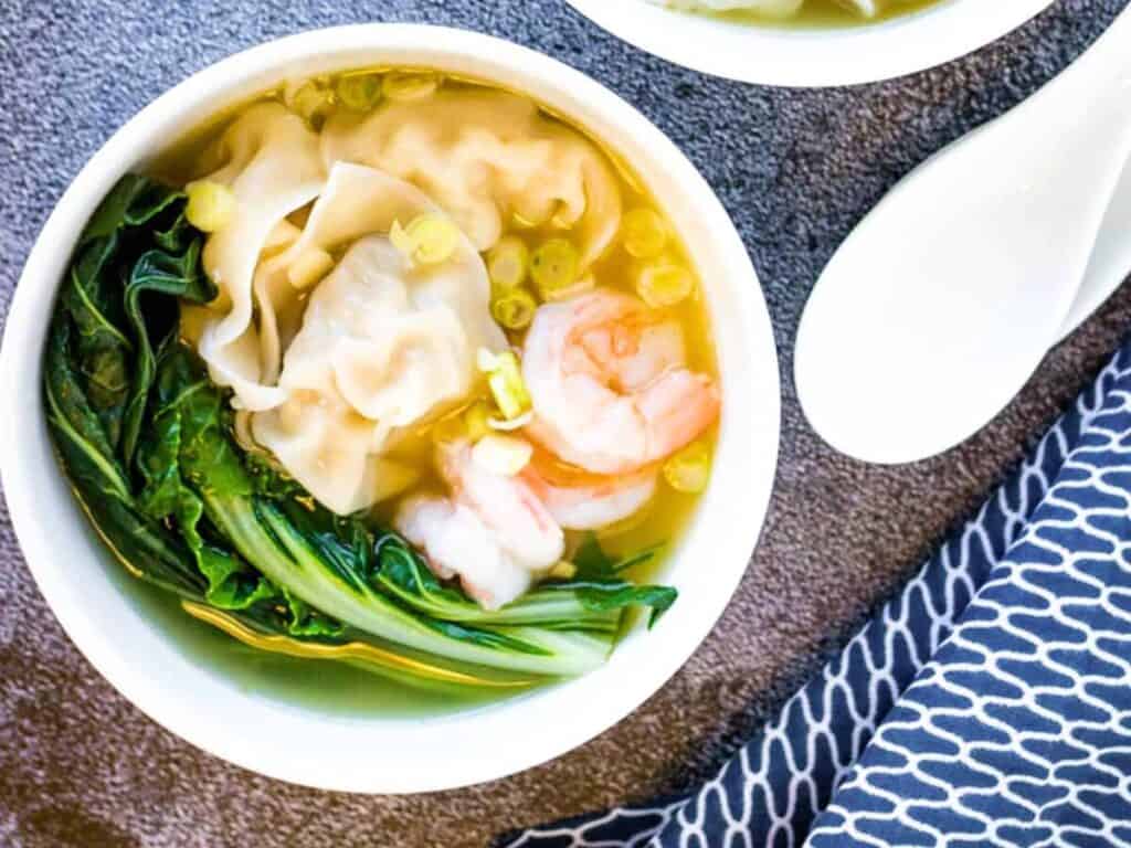 Image shows yummy pork and shrimp wonton soup.
