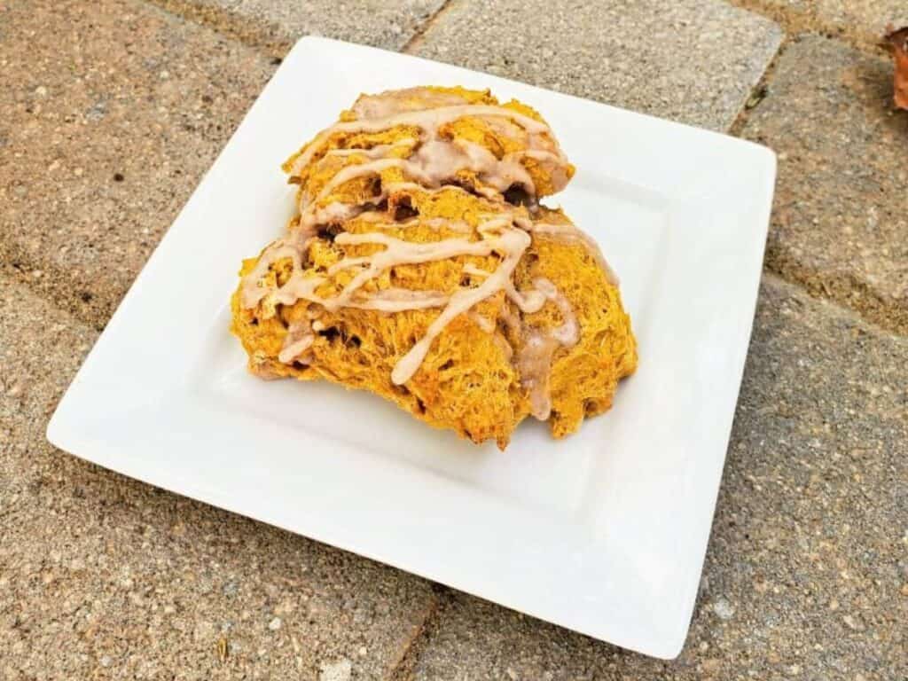 Image shows yummy pumpkin scones served on a plate.