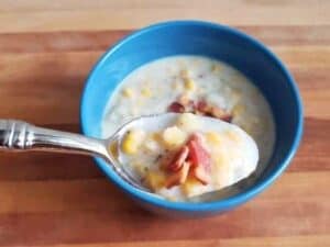 Image shows bite of yummy potato corn chowder.
