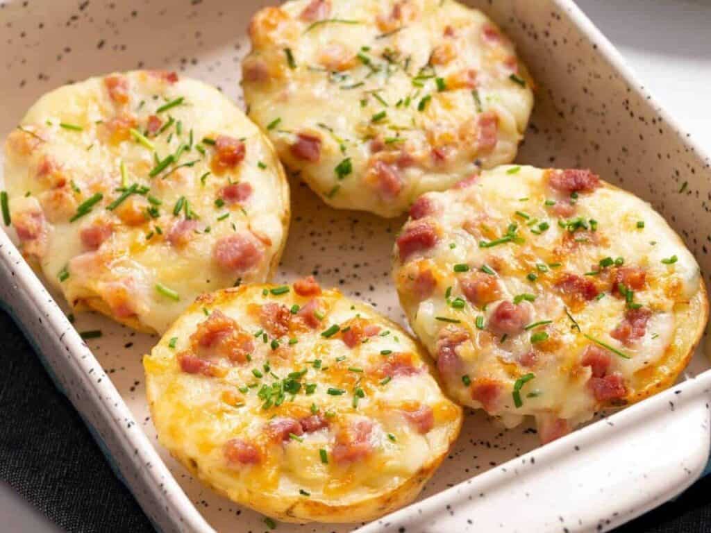 Image shows delicious cheesy loaded twice baked potatoes.