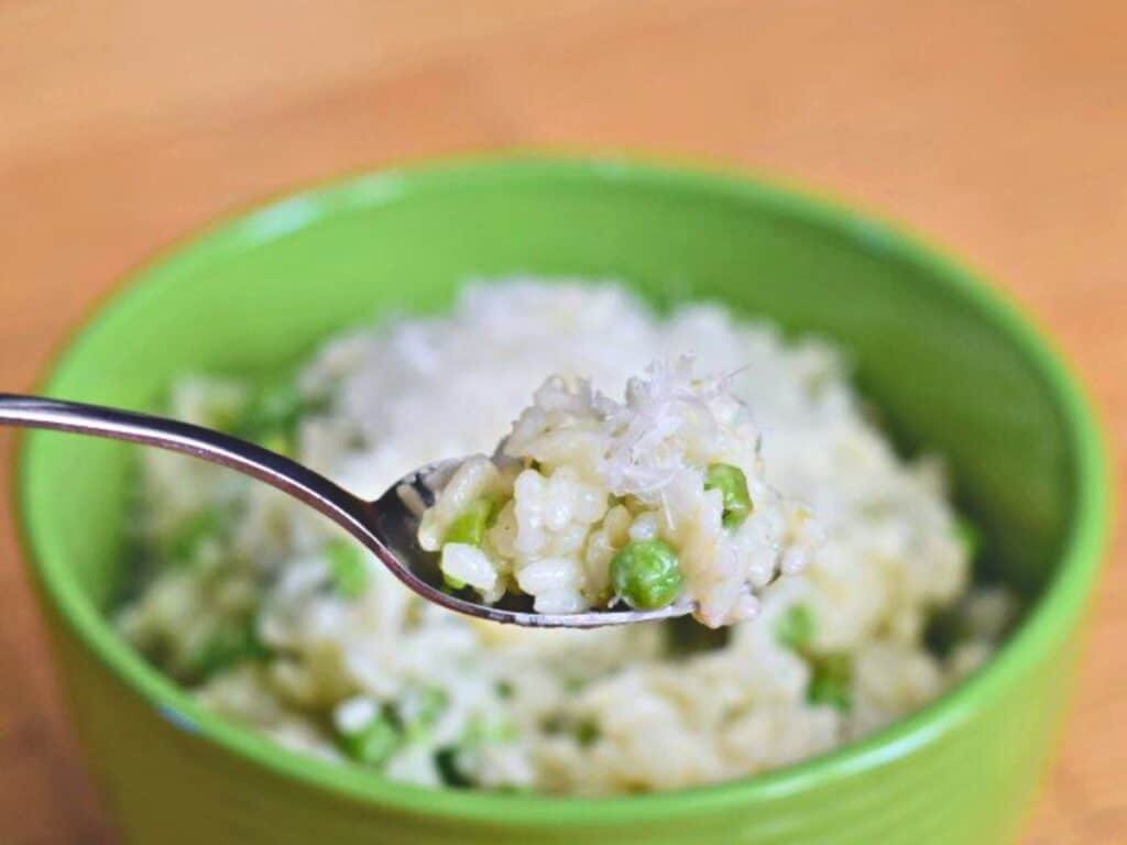 Image shows delicious instant pot risotto with peas and lemon.