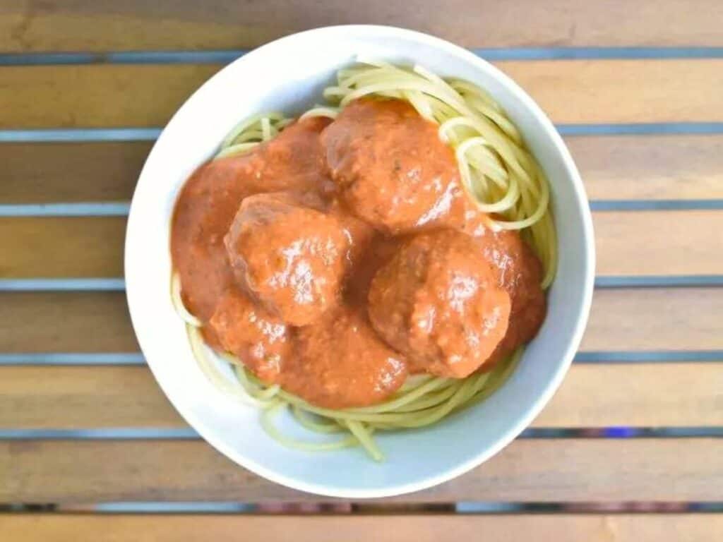 Image shows easy to make instant pot spaghetti and meatballs.