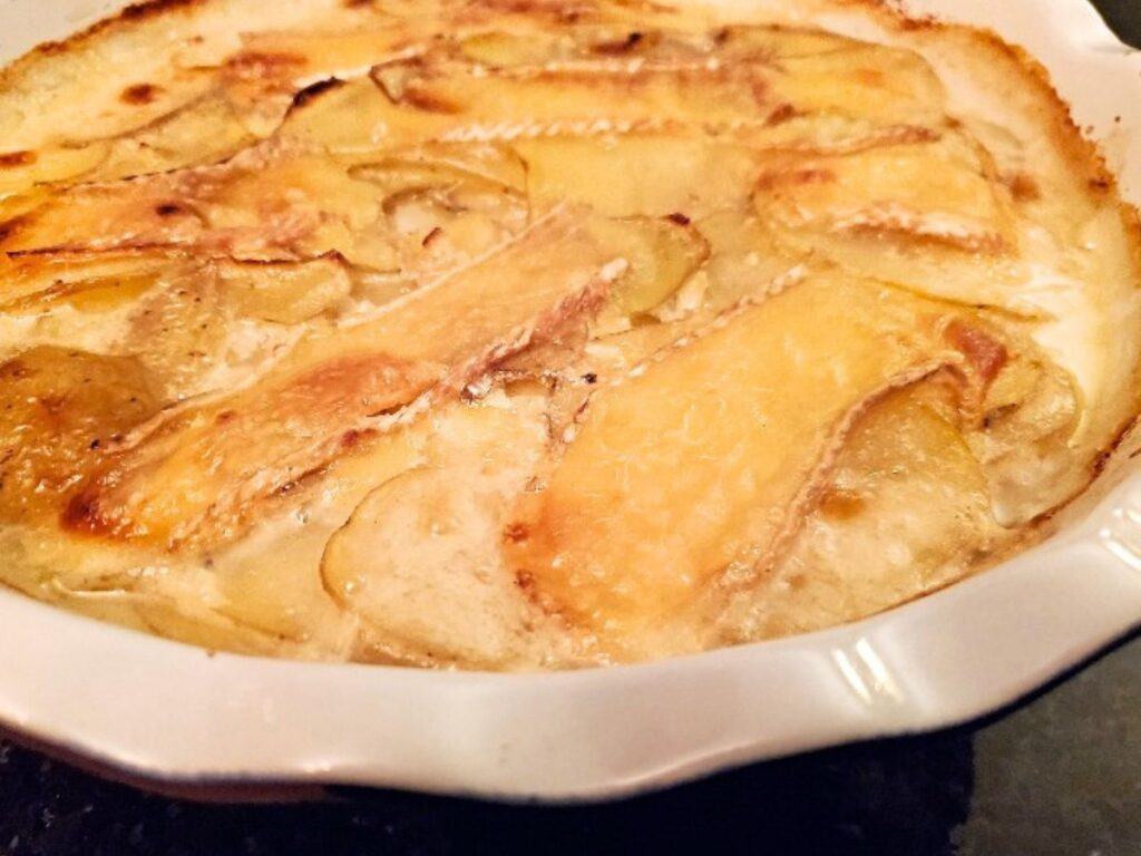 Image shows easy to make smoked brie potato gratin.