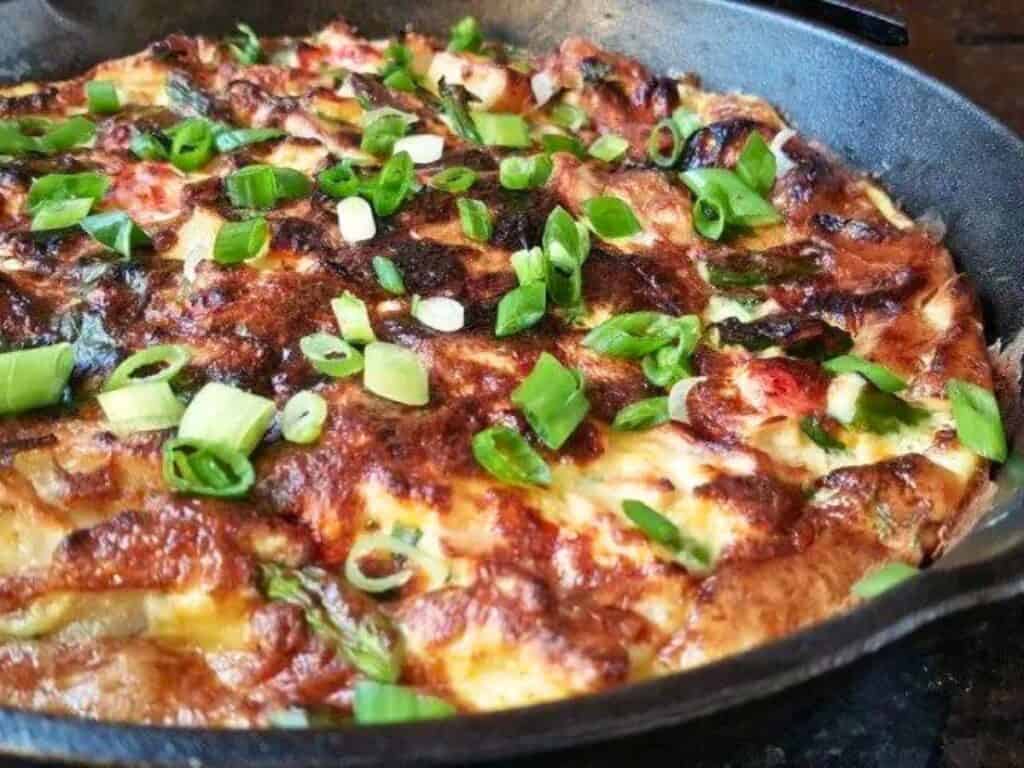 Image shows green onion added to nicoise dinner omelet.