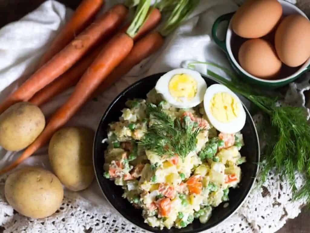 Image shows irresistible Russian potato salad.