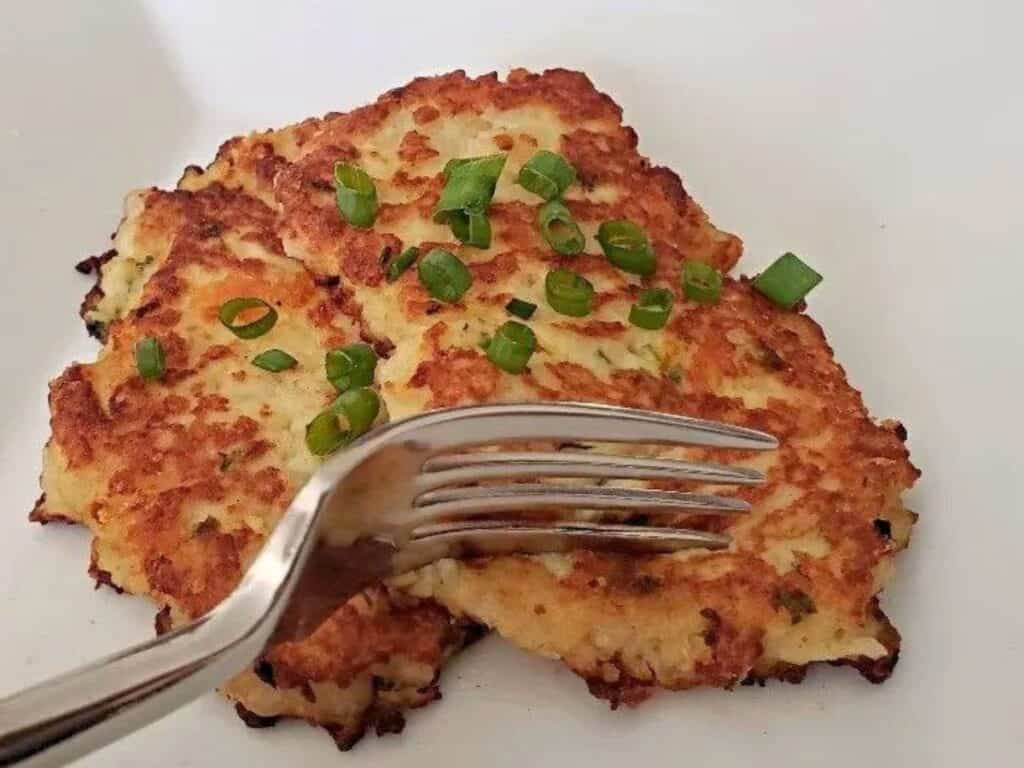 Image shows irresistible loaded mashed potato pancake.