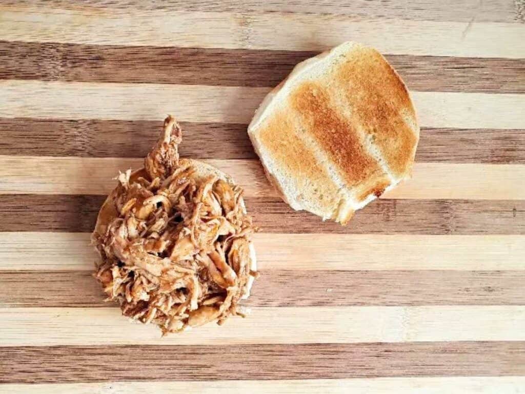 Image shows irresistible shredded BBQ chicken sandwich.